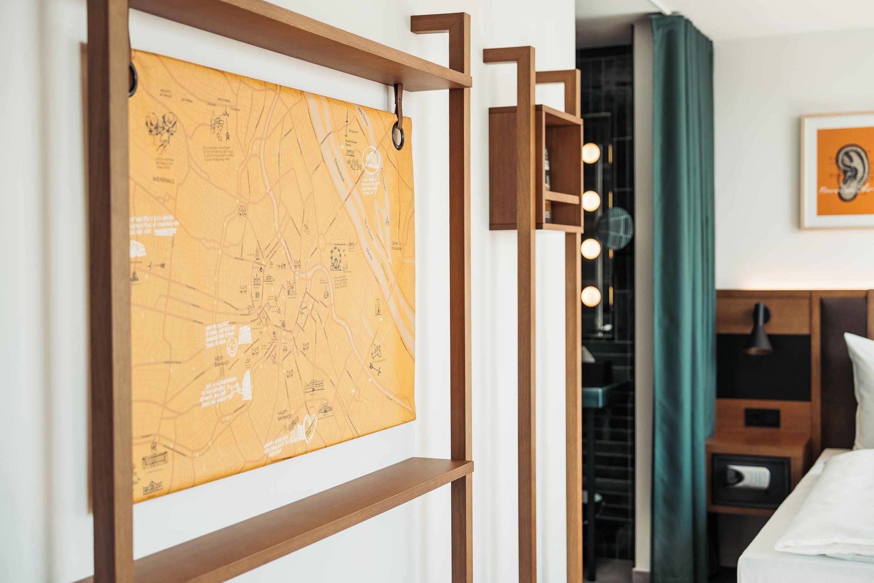 A map on a wall, a bed, a headboard, a mirror, and a curtain.