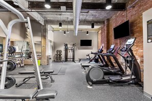 A gym with treadmills, weight machines, and a squat rack. - Historic Loft Retreat With Pool (Pittsburgh)