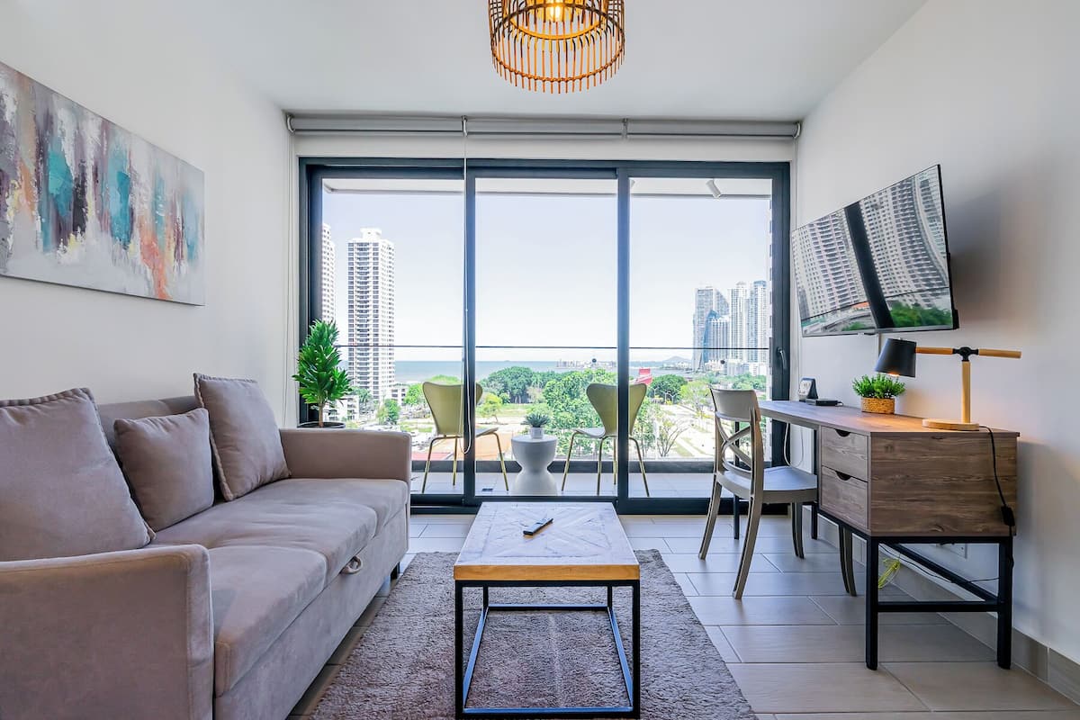 Apartment, Balcony | Living area | 55-inch Smart TV with cable channels