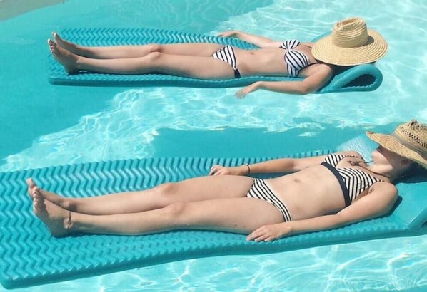 Relax by the pool with seats on floating mats.
