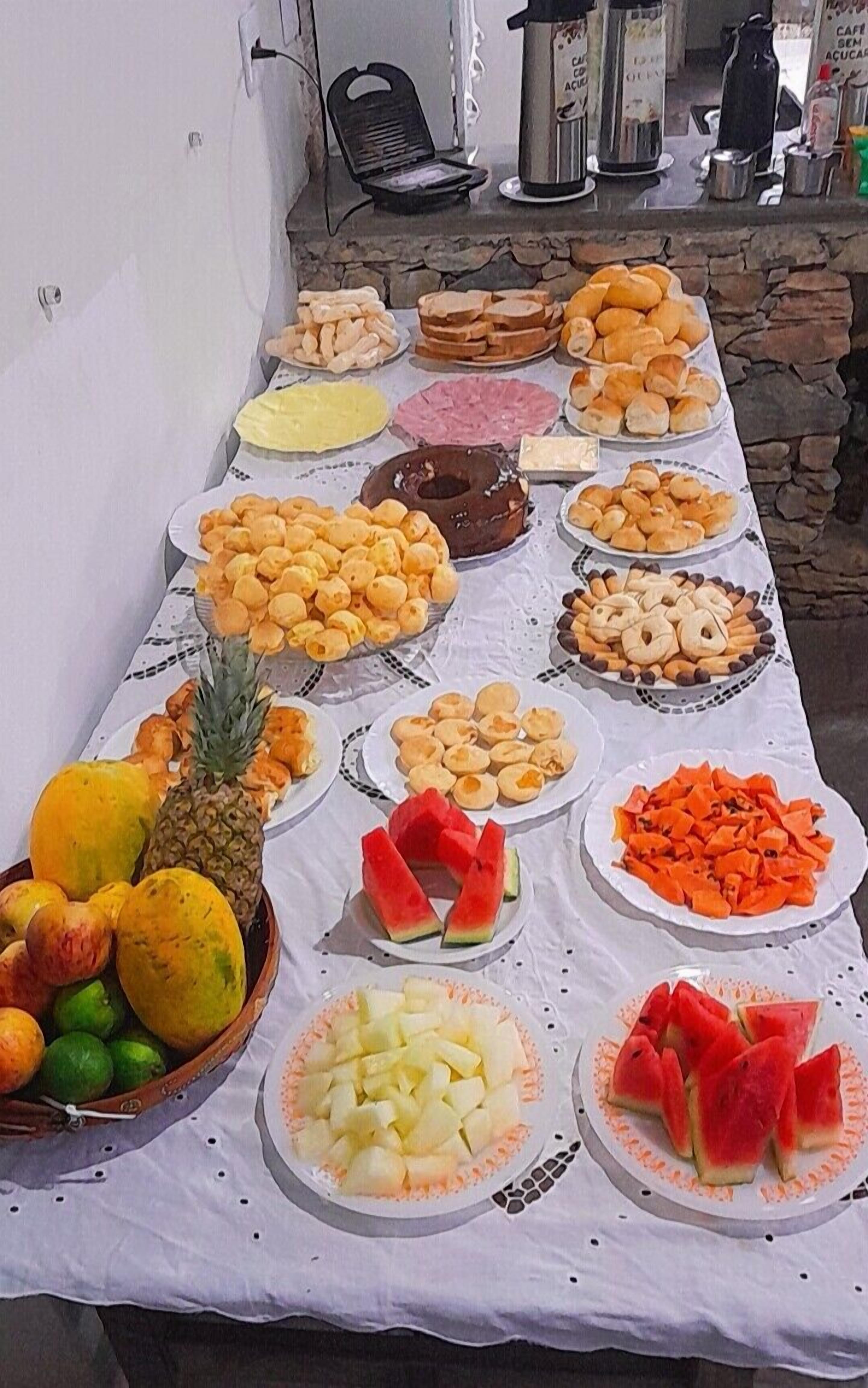 A table with various food items and a coffee machine.
