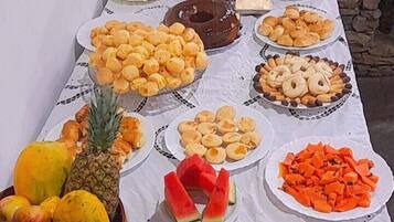A table with various food items and a coffee machine.