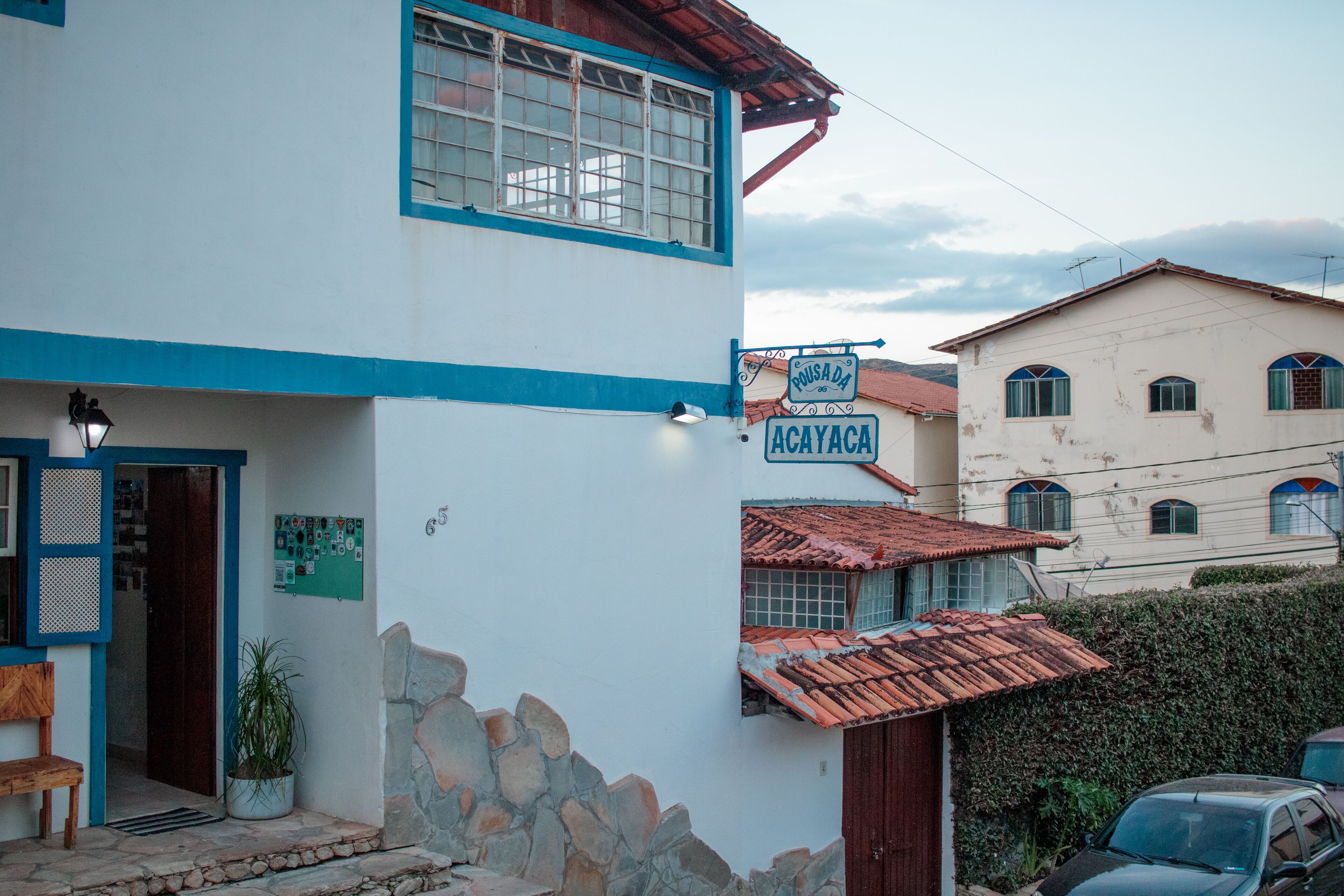 A two-story building with a sign reading "Pousada da Acayaca."
