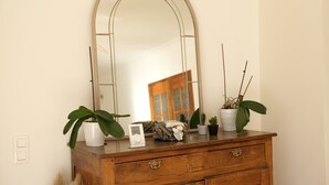 A wooden dresser with a large mirror, potted plants, and a small clock. - Vacation rental house with pool MOURIES LS1-434 (Mouriès)
