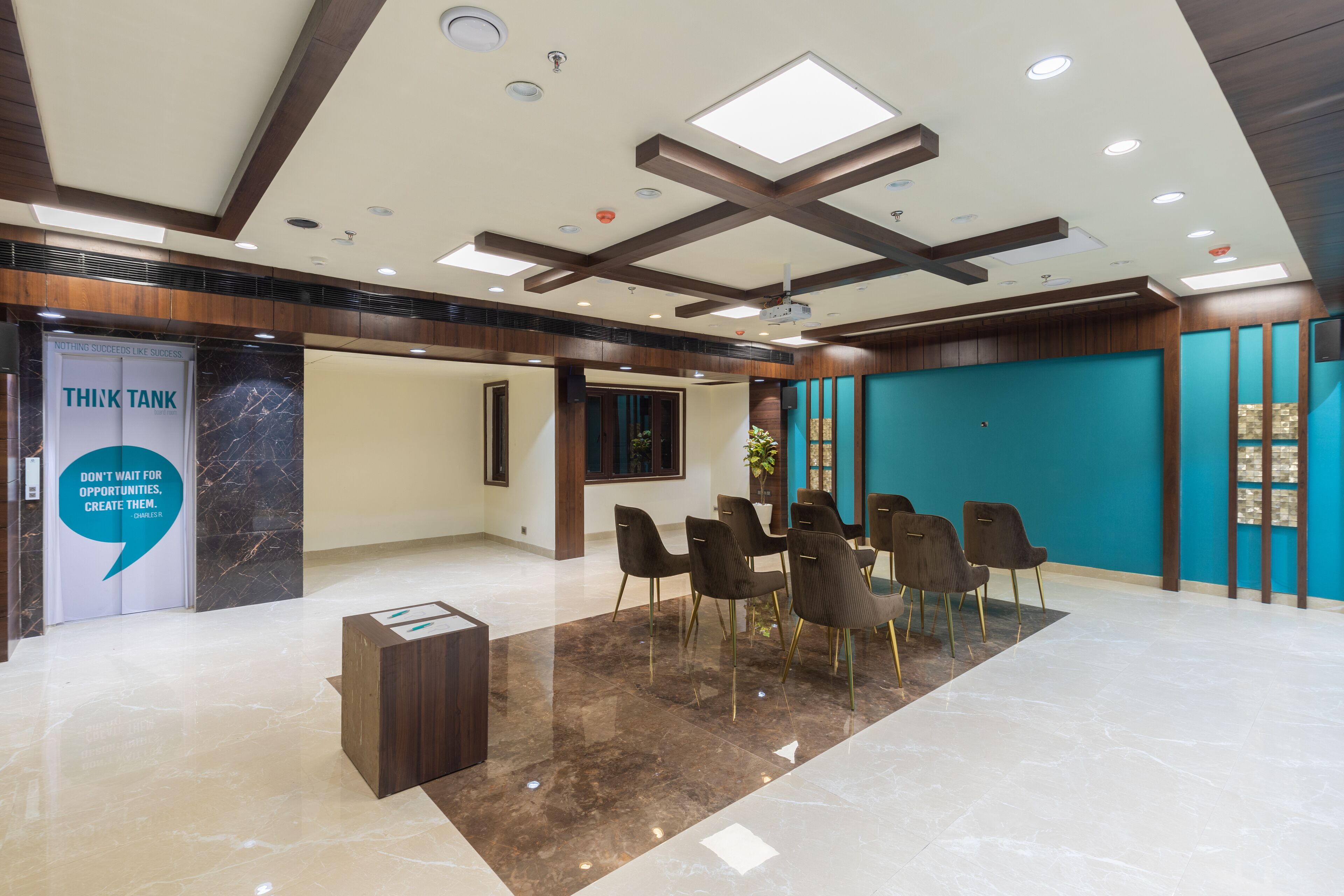 A modern lobby with a marble floor, a reception desk, and a seating area with chairs.