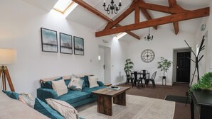 Ein gemütliches Wohnzimmer mit Sofa, Couchtisch und Essbereich.