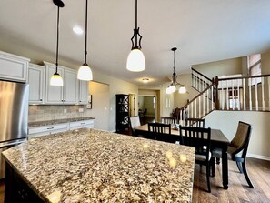 A kitchen with granite countertops, stainless steel appliances, and pendant lighting. - Large Executive Home In Lebanon Golf Community (Lebanon)