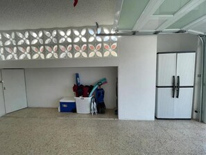 A room with a white door, a white cabinet, and a ceiling fan. - Fajardo Family Vacation Home + Solar Backup + Game Room (Fajardo)