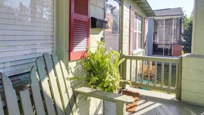 A porch with a bench, a potted plant, and a view of a neighboring house. - Savannah Home w/ Yard ~ 3 Mi to Downtown! (Savannah)