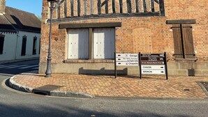 A traditional building with a tiled roof, a signboard with directional arrows, and a street lamp. - Château region/Sancerre Loire Valley large family house! Spacious w/courtyard! (Pierrefiette sur Sauldre)