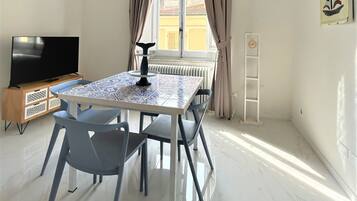 Family Suite | Living area | 40-inch Smart TV with satellite channels