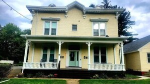 A two-story house with a front porch, a central entrance, and a small front yard. - TROY, NY Studio near Emma Willard (Troy)