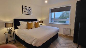 Premium bedding, desk, laptop workspace, soundproofing