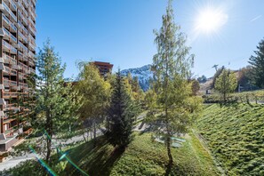 Set amidst lush greenery and a mountain backdrop, this building offers a unique blend of architecture and nature.