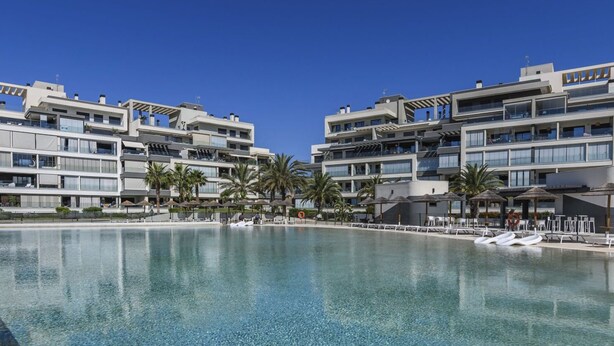 A modern hotel with a large pool, multiple balconies, and palm trees. - Ocean Homes 5203 - Two Bedroom Apartment, Sleeps 5 (Punta del moral)