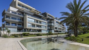 A multi-story hotel with balconies, a swimming pool, and palm trees. - Ocean Homes 5203 - Two Bedroom Apartment, Sleeps 5 (Punta del moral)