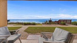A patio with outdoor seating and a view of the ocean. - SPECTACULAR FIRST FLOOR “BEACHFRONT”
CONDO COMPLETELY RENOVATED ON CRYSTAL BEACH (Destin)