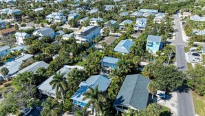 An aerial view of a residential area with houses, roads, and palm trees. - Blue Hideaway- 5 bedroom with Separate Guest House, Private Pool/Spa! (Anna Maria)