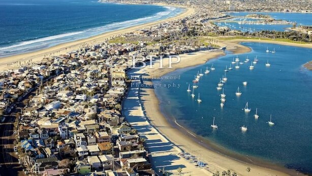 An aerial view of a coastal town with a beach, boats, and residential buildings. - Tuluminati:BohoChic Condo Steps from Ocean and Bay (San Diego)