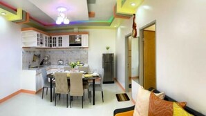 A compact living space with a kitchen, dining area, and a small seating area. - Tranquil Retreat: Inviting 2BR Condo in Zamboanga (Zamboanga)