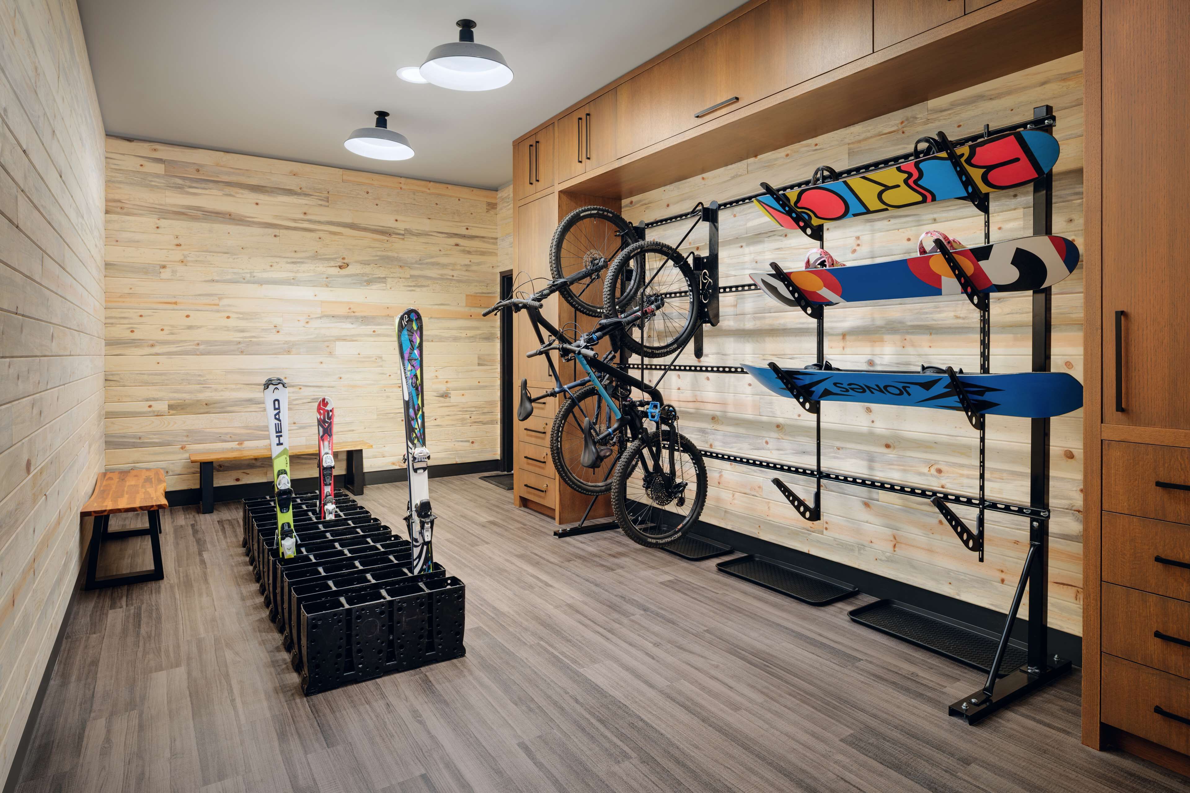 A room with wooden walls, a bike rack, and a bench.