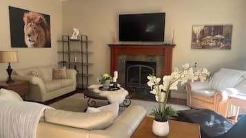 Smart TV, fireplace, books, computer monitors