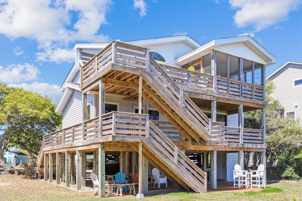 Staircases connect multiple levels in this multi-level structure, offering views of the surrounding landscape through glass walls.