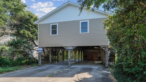 A two-story house with a garage attached to the front. - Sunseeker -- Beat the traffic with a Friday arrival/3 BR Cottage in Kitty Hawk (Kitty Hawk)