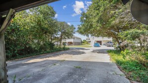 A residential driveway leading to a house with a garage. - Sunseeker -- Beat the traffic with a Friday arrival/3 BR Cottage in Kitty Hawk (Kitty Hawk)