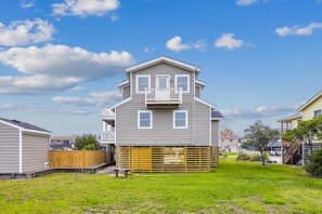 A two-story house with a front porch and a small deck. - Gone to Carolina -- Recently Remodeled Home with Pool, Hot Tub, & Putting Green (Kitty Hawk)