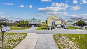 A residential area with houses, a basketball court, and a clear sky. - Gone to Carolina -- Recently Remodeled Home with Pool, Hot Tub, & Putting Green (Kitty Hawk)