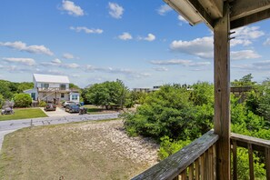 A residential area with a two-story house, a driveway, and a wooden deck. - Doris's Day-- 4BR Oceanside home in Duck with Private Hot Tub (Duck)