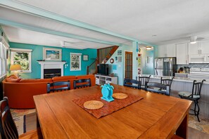 A dining area with a wooden table, chairs, and a blue decorative piece.