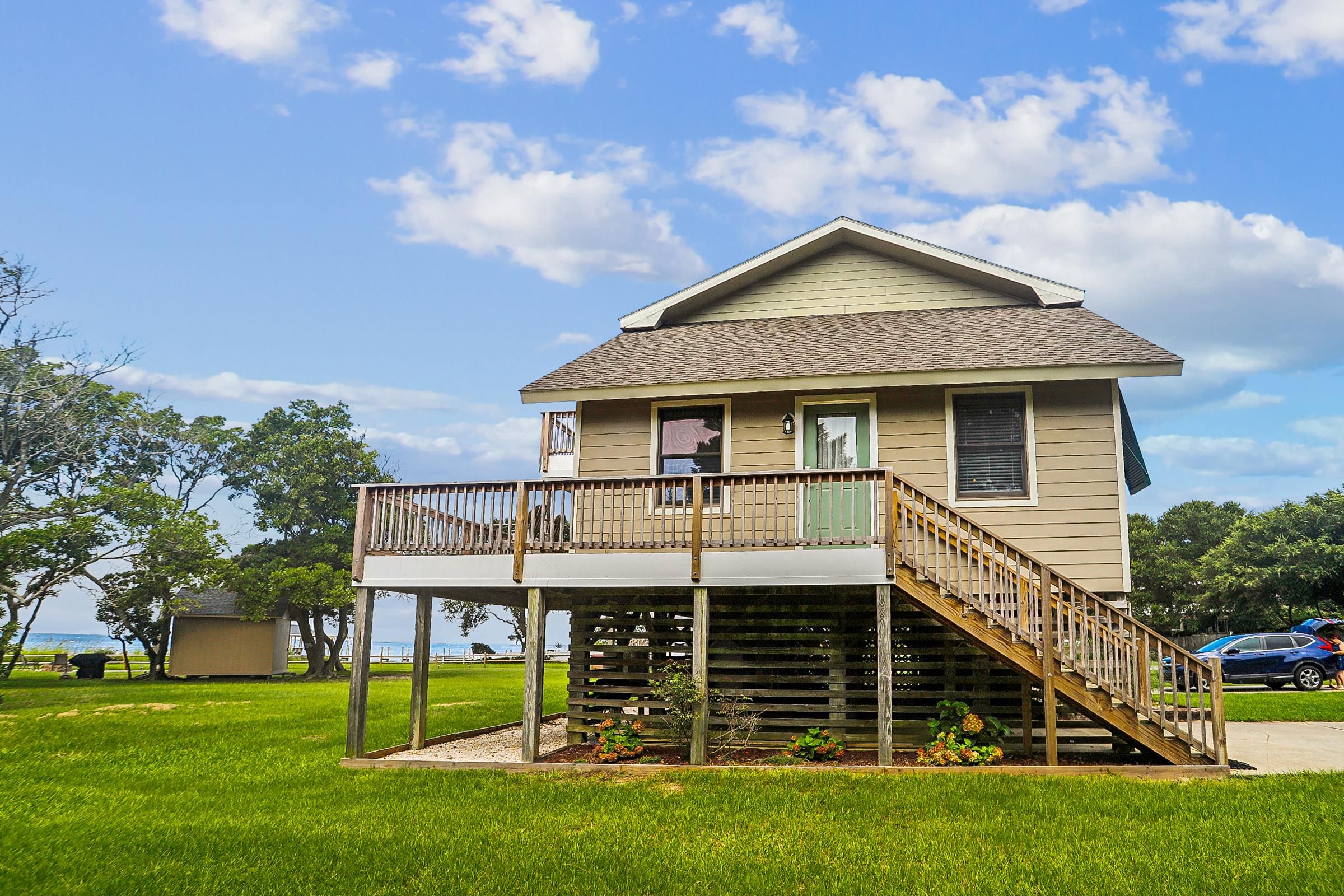 A two-story house with a balcony and a staircase leading to the second floor.