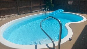 A swimming pool with a metal ladder and a 'No Swimming Allowed' sign. - Flamingo -- Pet Friendly Home with Private Pool and Gameroom (Nags Head)