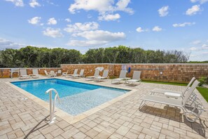 A rectangular swimming pool with a wooden deck and lounge chairs. - Newbern - New Cons. Semi Oceanfront in Corolla with Fire Pit, Elevator, Hot Tub and More! (Corolla)