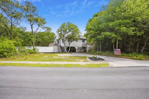 A two-story house with a front porch, a garage, and a driveway. - House of Friends -- New Listing!  Private Pool, Easy Beach Access (Kitty Hawk)