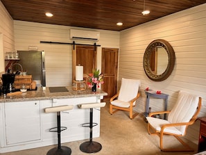 Enjoy cooking in this well-equipped kitchen with a central island, stainless steel appliances, and ample seating.