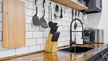 Fridge, microwave, coffee/tea maker, cookware/dishes/utensils