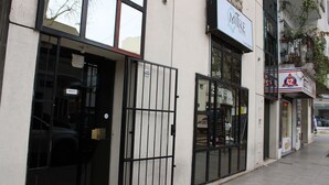 A building with a sign for 'MITRE SUITES' and a visible entrance with a metal gate. - Mitre Suites Hotel (Buenos Aires)