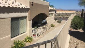 A residential building with a balcony, a covered patio, and a view of a desert landscape. - Special Summer Rates 1-6 Months Begin April Near Restaurant & Shopping (Fountain Hills)