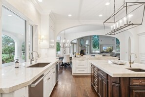 Enjoy cooking in this well-lit kitchen with a large island, sink, and ample counter space.