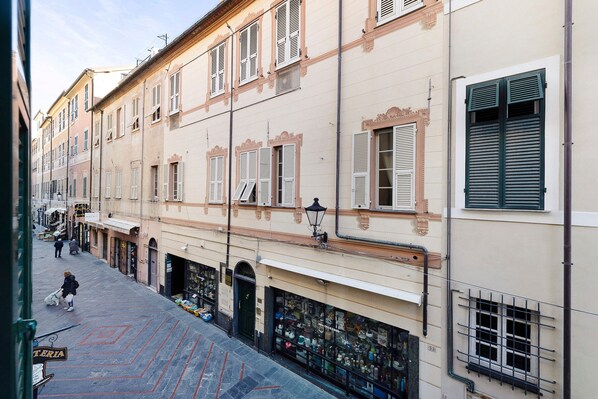 A street view with buildings, shops, and a pedestrian.