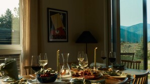 A dining table set for a meal with wine glasses, a pitcher, and plates of food. - Mountain Home By Aspects | Sauna Access + Firepit (Big Sky)