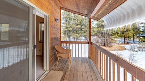A wooden deck with a view of trees and snow. - Pet Friendly TreeHaven Retreat (Pagosa Springs)