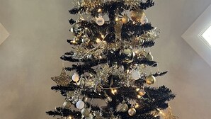 A Christmas tree with gold and silver ornaments, a star on top, and a glittery base. - Easy Rider Cabin -Boat/Trailer prkg, Pet ok w/fee (Medicine Park)