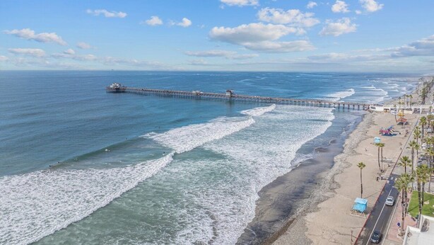 A pier extending into the ocean with a beach and palm trees on the shore. - Rooftop Ocean-View Home, Private Parking, Near Beach (Oceanside)