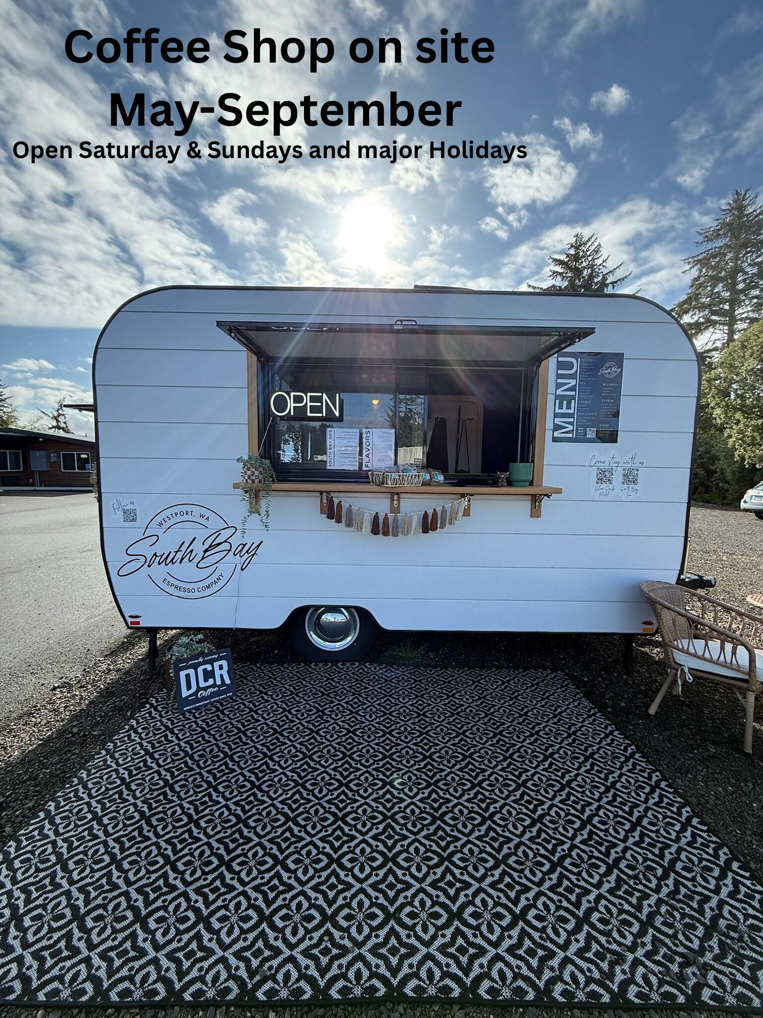 A mobile coffee shop branded as 'South Bay Espresso Company' with a menu board, open sign, and seating area.