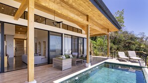 A modern house with a pool, large windows, and outdoor seating. - La Joya De La Selva ~ An Eco-Luxury Experience (Nosara)