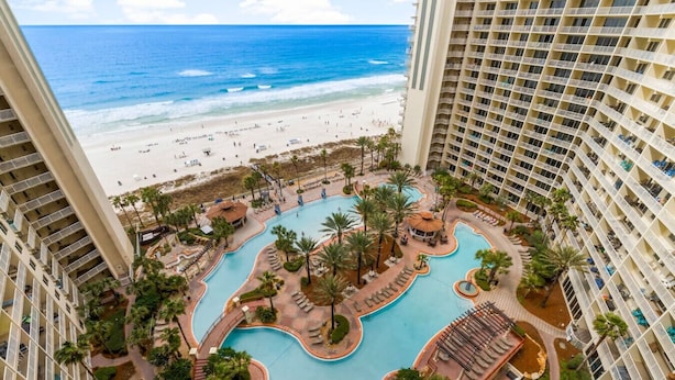A resort with a central swimming pool, multiple balconies, and a beach view. - Oceanfront, Swimming Pool, 14th Floor Condo (Panama City Beach)